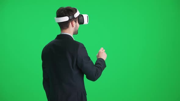 Man in Futuristic Virtual Reality Glasses Controls the Virtual Interface with a Hands Movement