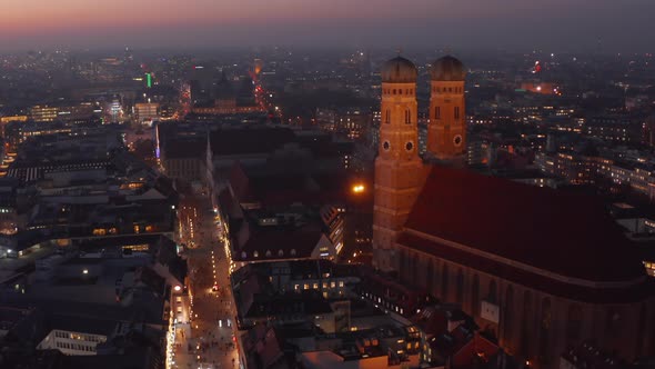 The Famous Frauenkirche Church Cathedral in Munich at Night Aerial Dolly Forward Approaching Two