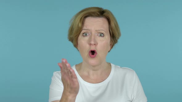 Fighting Old Woman in Anger Isolated on Blue Background