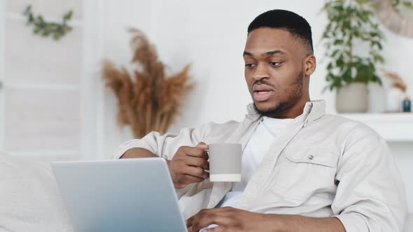 African Man Young Afro Student Ethnic Black Male Sitting at Home Holding Cup with Hot Tea Coffee
