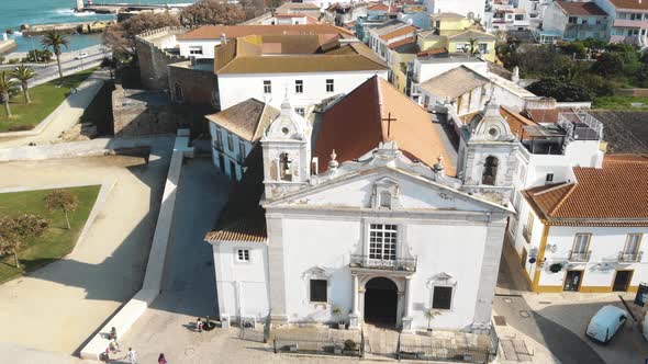 Top view of Church of Santa Maria de Lagos and reveal of Atlantic coast