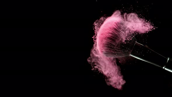 Super Slow Motion Closeup Shot of Pink Makeup Powder Falling From Facial Brush at 1000Fps