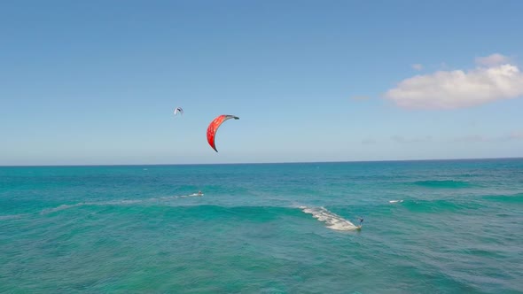 Aerial view of a man kitesurfing in Hawaii.