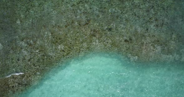 Tropical birds eye clean view of a white sand paradise beach and aqua blue water background in high 