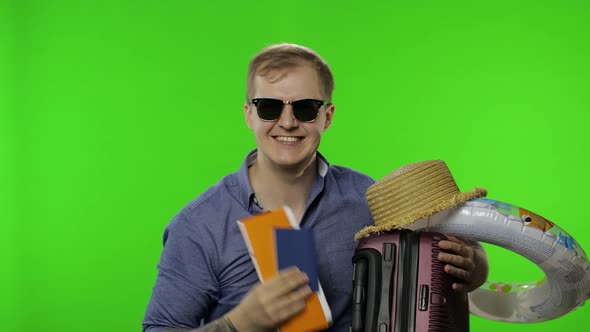 Portrait of Man Tourist with Suitcase Celebrates, Ready for Vacation