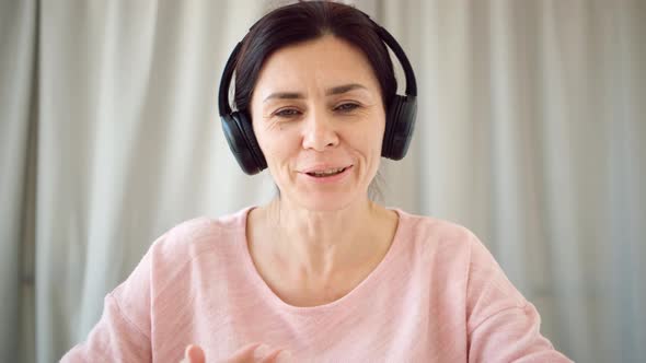 Teacher in Headphones During Online Lesson