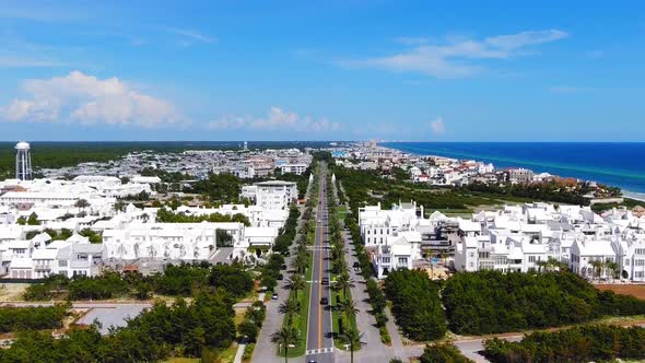 Aerial View of Alys Beach slowly lowering to show the entrance, a lot of white modern houses on the