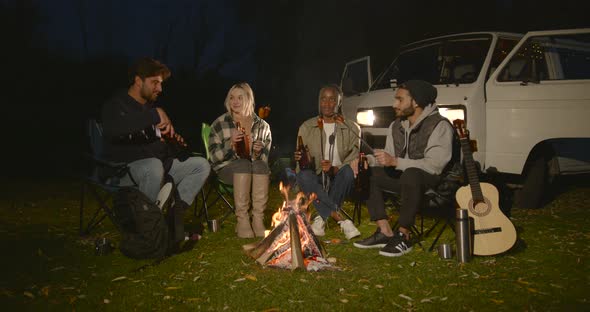 Multiracial Friends Having a Picnic By Fire