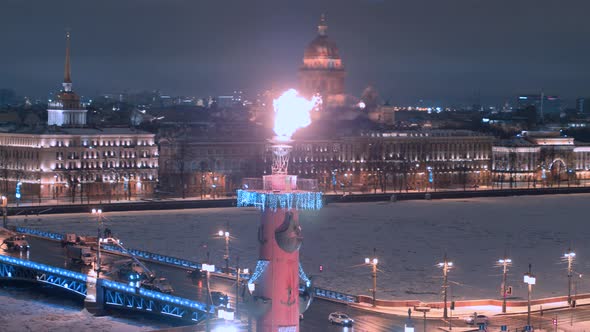 Rostral columns with a lit torch in Saint Petersburg winter time.