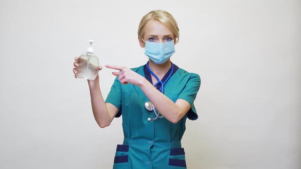 Medical Doctor Nurse Wearing Protective Mask - Holding Sanitizing Spray or Gel or Liquid Soap