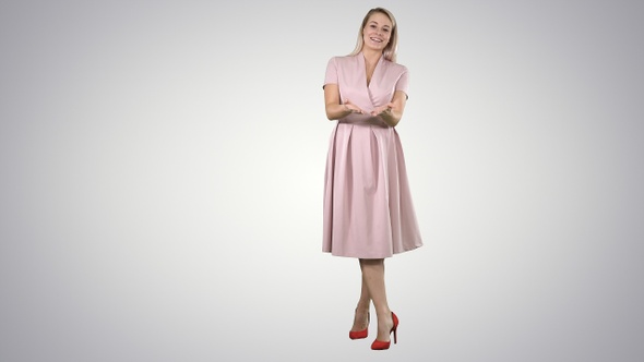 Happy Blonde Woman in Pink Talking to Camera and Pointing