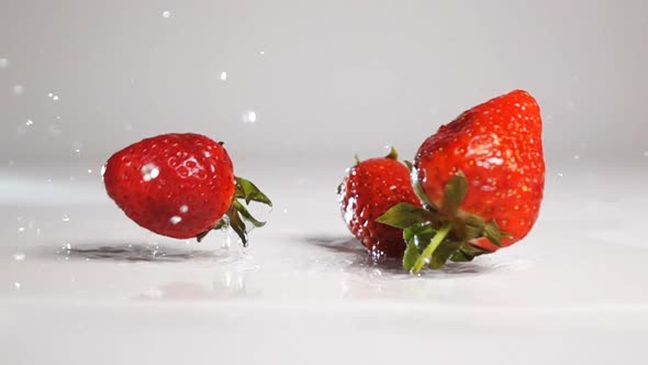 Strawberries Drop on White Wet Surface