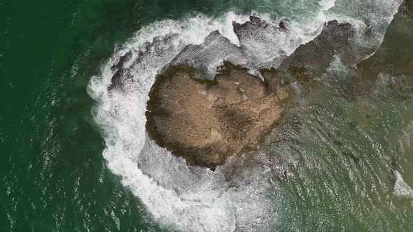 Ocean waves breaking on a rocky shore, Aerial view.