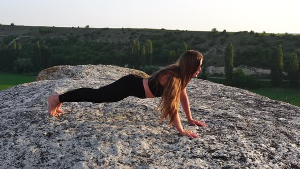 Young Woman with Long Hair Fitness Instructor in Black Sportswear Leggings and Tops Stretching