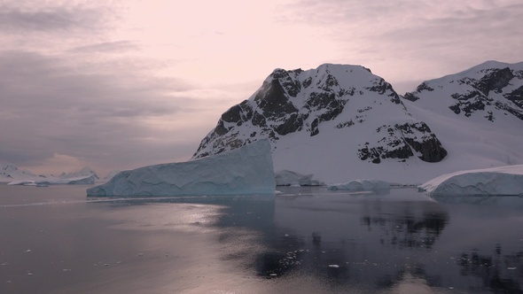 Antarctica. Icebergs. Global warming. Summer Midnight Sun and icebergs. Big blue ice in icefjord.