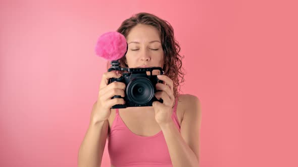 Portrait of a Young Beautiful Woman Using a Video Camera