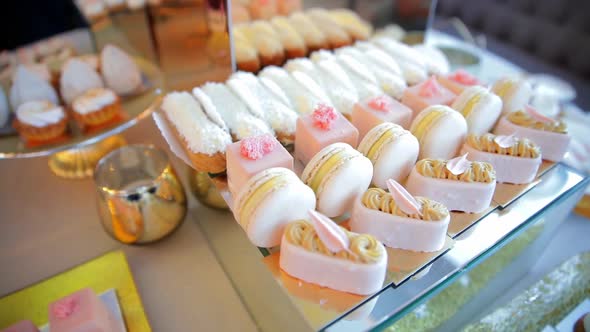 Table with Sweet Cookies, Eclairs, Cakes. Candy Bar