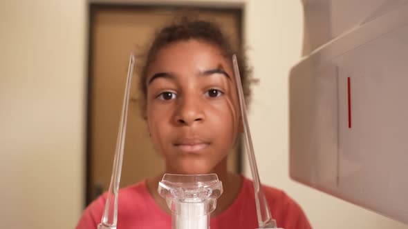 Mixed Race Girl Getting Dental Xray in Clinic