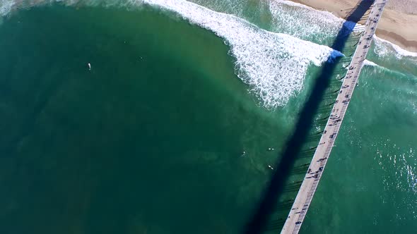 Aerial shot of surfers paddling out on the ocean.