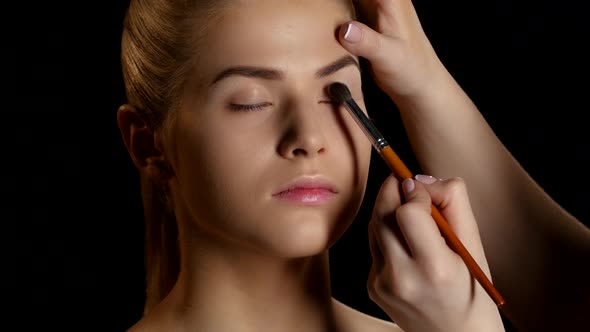 Eye Makeup Woman Applying Eyeshadow Powder. Makeup. Black. Closeup