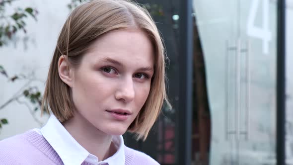 Young Woman Student with Short Fair Hair Waved By Light Wind