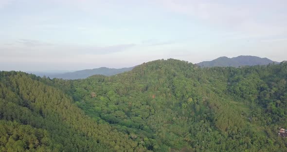 Aerial panoramic shot showing picturesque greened mountain range early in the morning