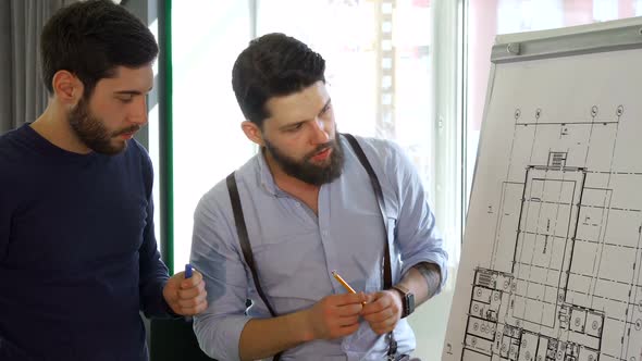 Architect Moves His Hand Over the Design of the Building