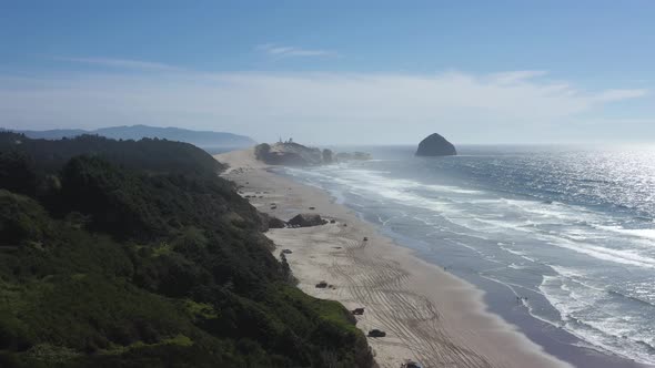 Aerial flying above a popular beach with scenic views near Pacific City, Oregon.
