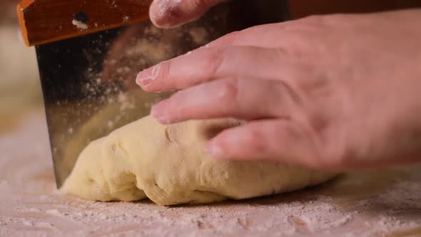 Cutting yeast dough with dough scraper