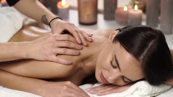 Therapist Massaging Woman Back at Spa
