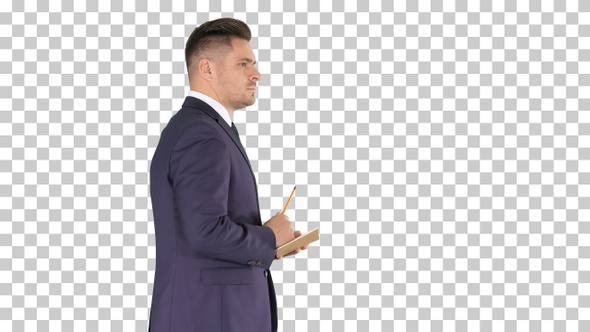 Young positive caucasian businessman walking and making checklist