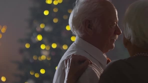 Elderly Couple Dancing Together on Christmas Eve