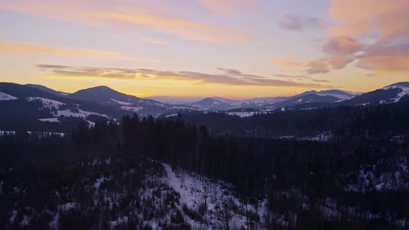 Beautiful Aerial  Shot of Snowy Mountains During Sunrise