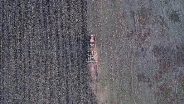 Aerial Top View of Farm Machinery Working on Cultivated Field