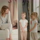 Mom Sits on the Closet and Looks at the Camera with Her Daughters - VideoHive Item for Sale