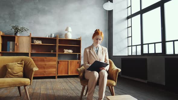 Female Psychologist Taking Notes and Planning Her Workday in Office