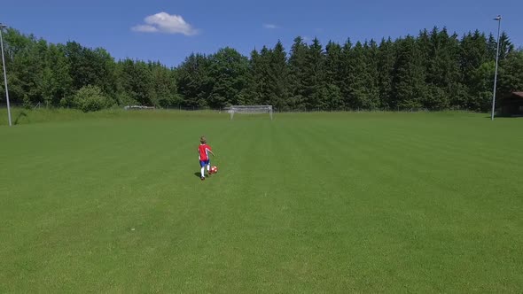 A young boy playing soccer on a soccer field