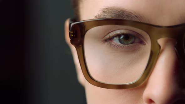 Macro of Focused Businesswoman Eye Looking Straight at Camera in Office