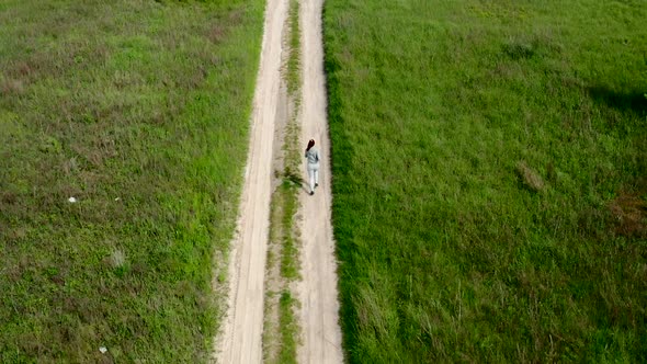 Young Sportswoman Runs on a Dirt Road  Slow Mo