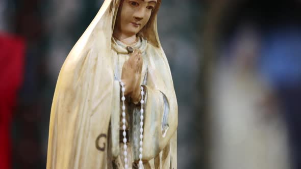 Close up panning shot of small Virgin Mary statue kept in table of church. Jesuit Missions of Chiqui