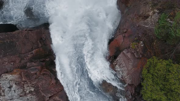 Overhead aerial camera captures a waterfall and rocky shores in Aguasabon Falls, Ontario, Canada