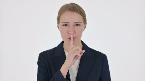 Young Businesswoman with Finger on Lips Silence White Screen