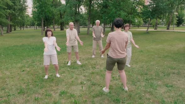 Group of Old People Practicing Tai Chi Chuan