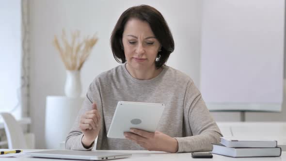 Senior Woman Reacting To Financial Loss While Using Tablet