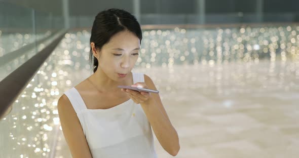 Woman use of cellphone in shopping center