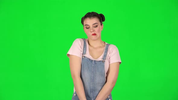 Girl Looks Upset at the Camera and Bites Her Lips Green Screen at Studio