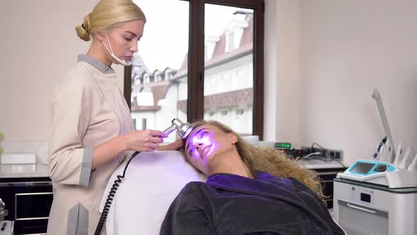 35-40 Aged Lady with Curly Hair in Cosmetology Cabinet which Having Ultrasonic Peeling