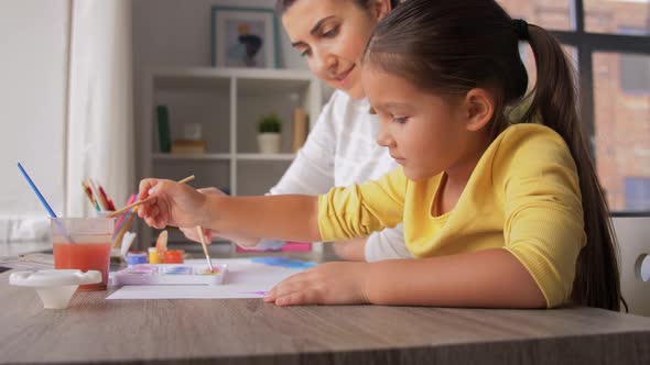 Mother with Little Daughter Drawing at Home