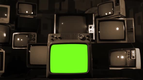 Piled Vintage TV with Green Screen. Sepia Tone. Aesthetics of the 80s.