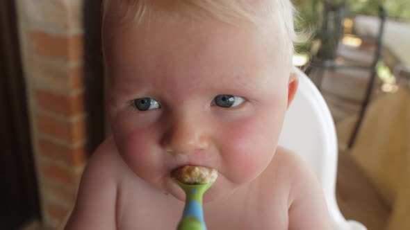 Cute Baby Boy Eating Puree in the Patio